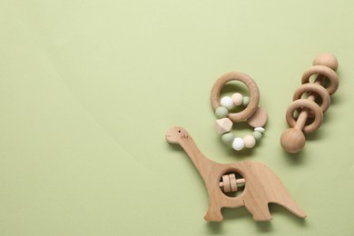 Different baby rattles on color background, flat lay. Space for text