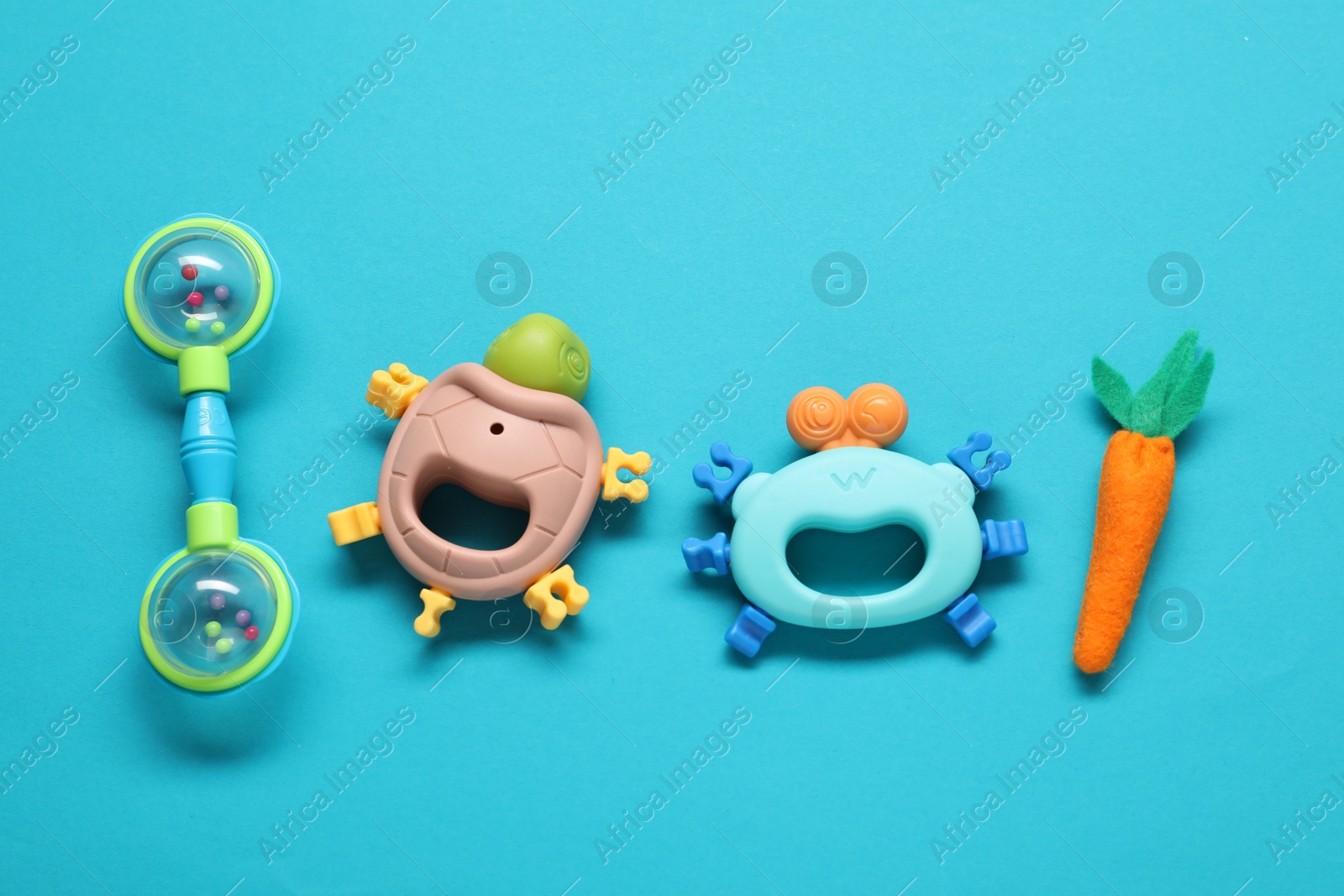 Photo of Different baby rattles on light blue background, flat lay