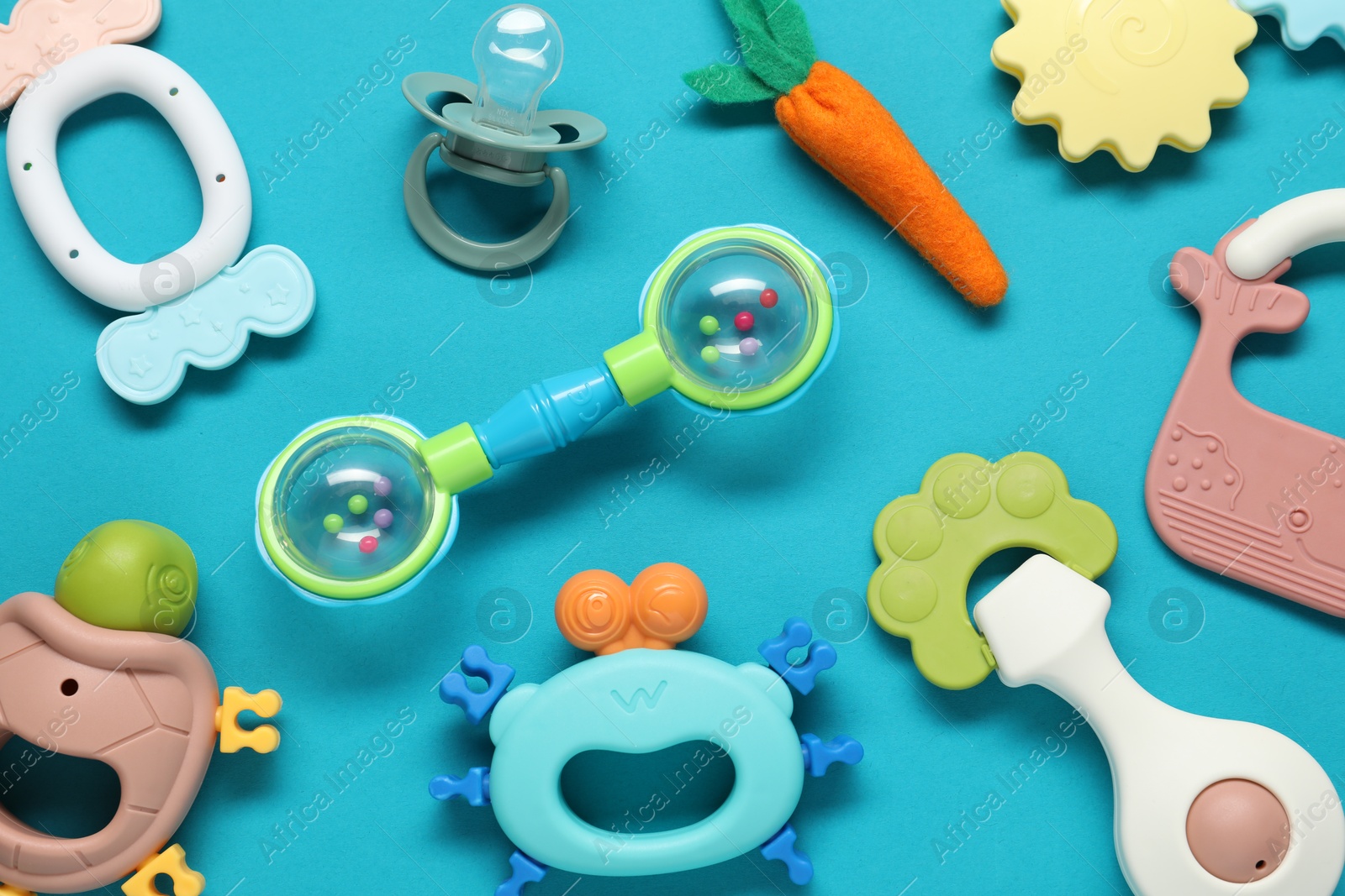 Photo of Different baby rattles on light blue background, flat lay