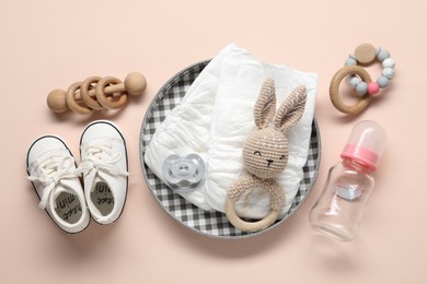 Photo of Baby accessories on beige background, flat lay