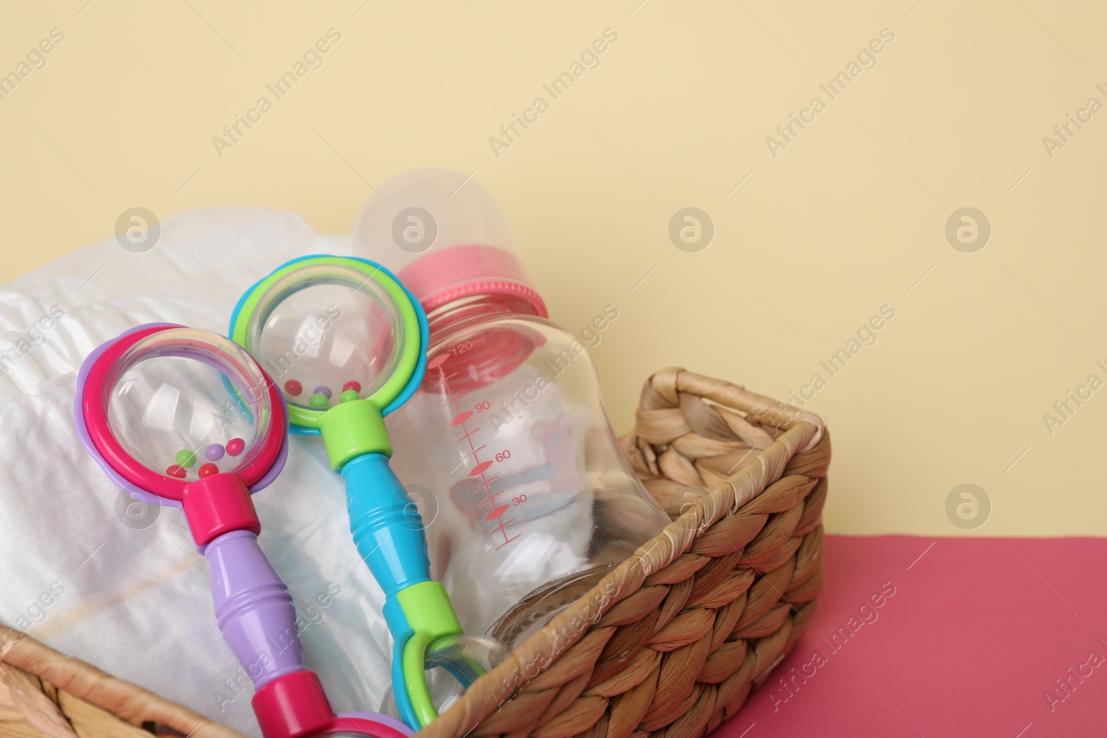 Photo of Baby accessories in box on color background, closeup