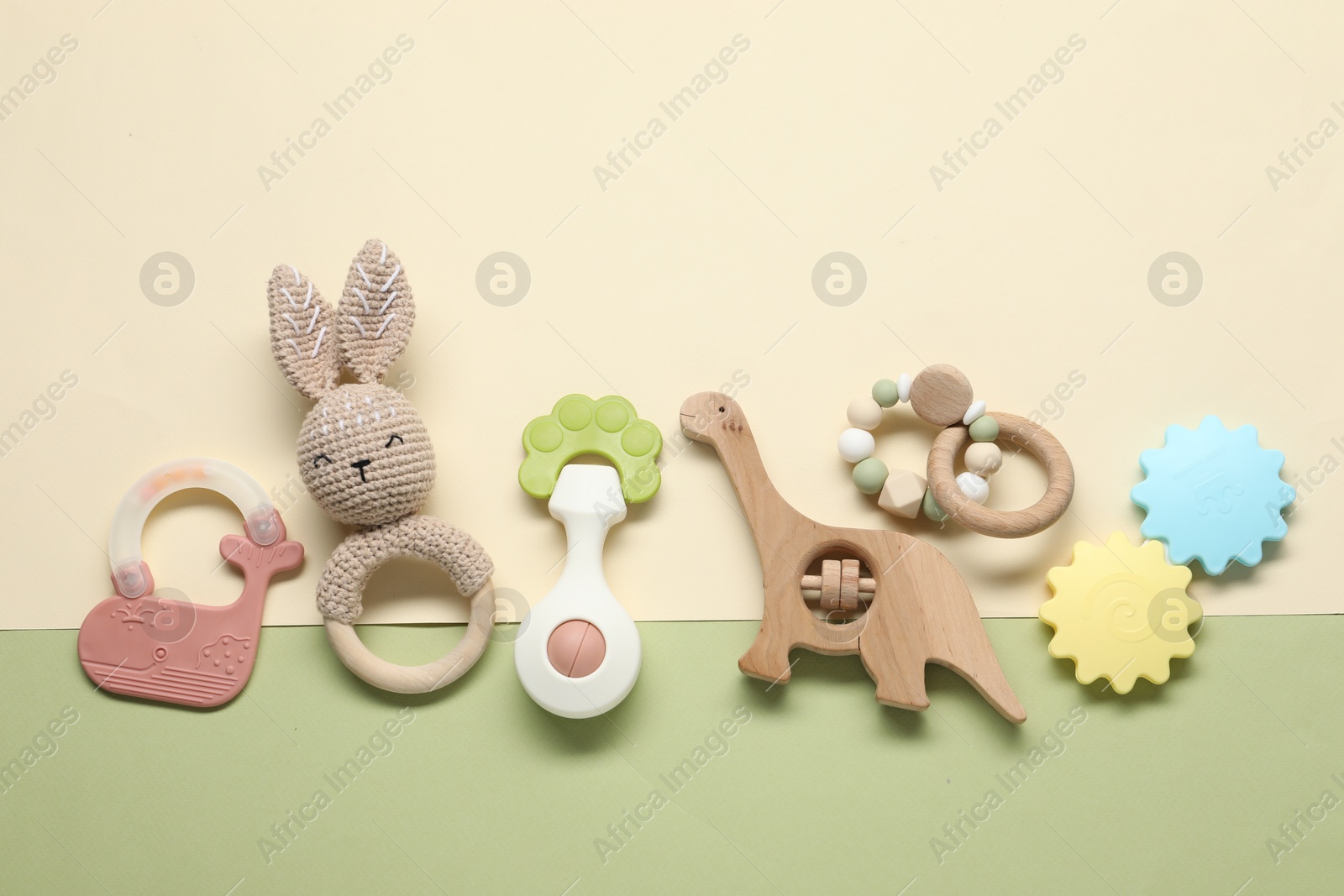 Photo of Different baby rattles on color background, flat lay