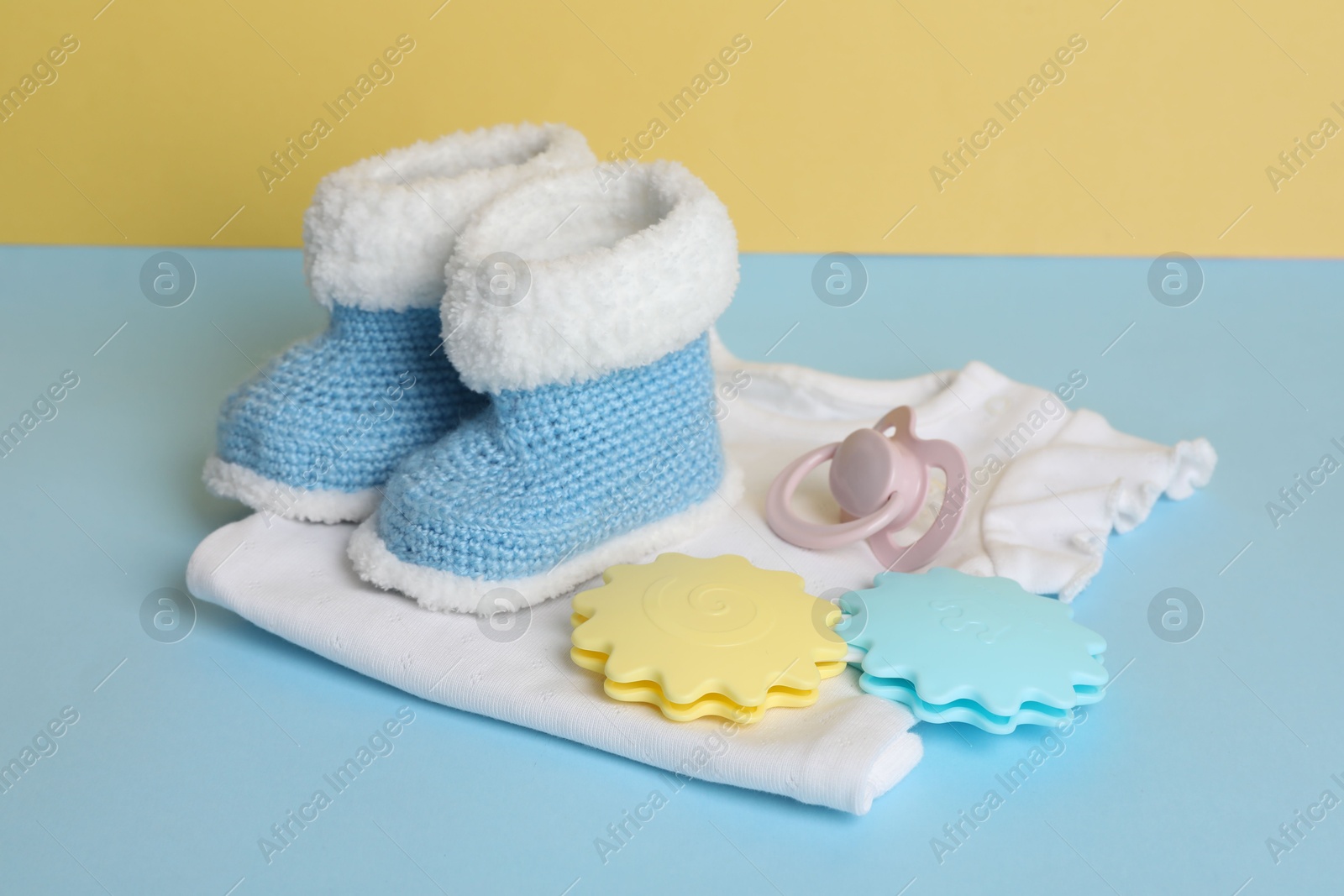 Photo of Different baby accessories on light blue table