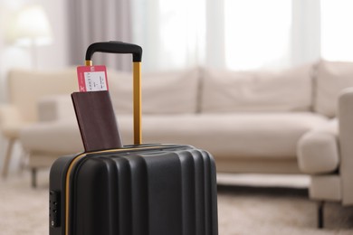 Black suitcase, passport and ticket at home, space for text