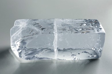 Piece of clear ice on light grey table