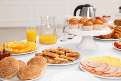 Different meals served on white table indoors. Buffet menu