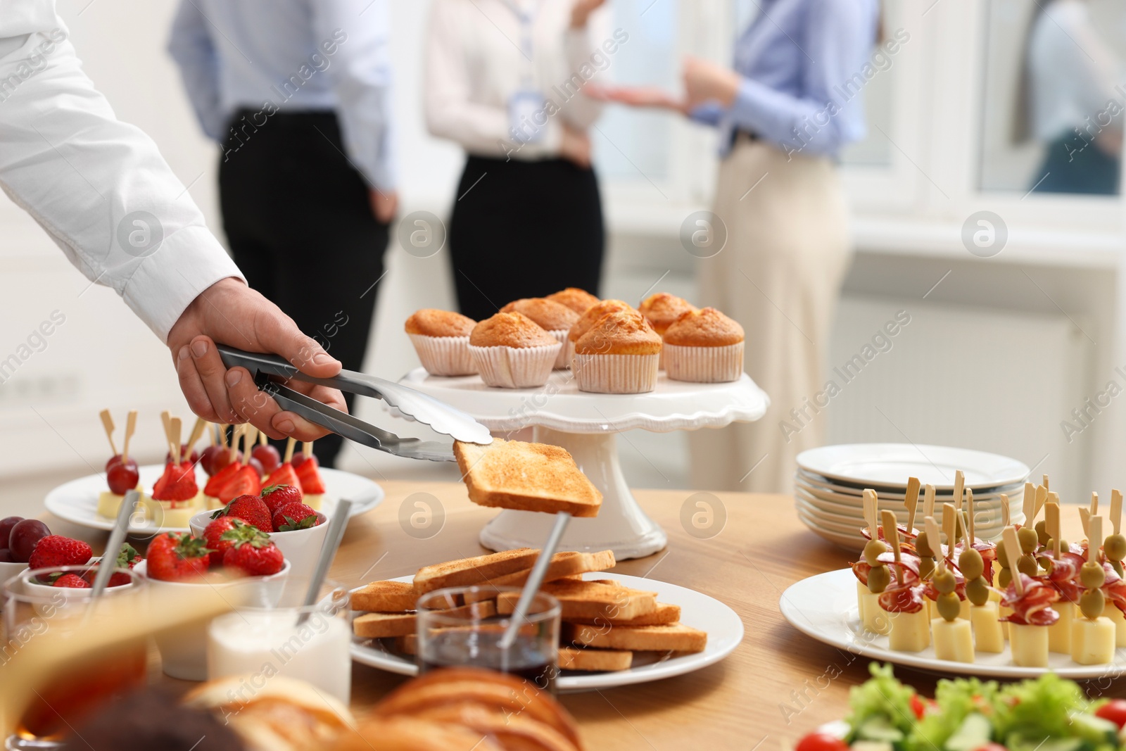 Photo of Coworkers having business lunch in restaurant, closeup