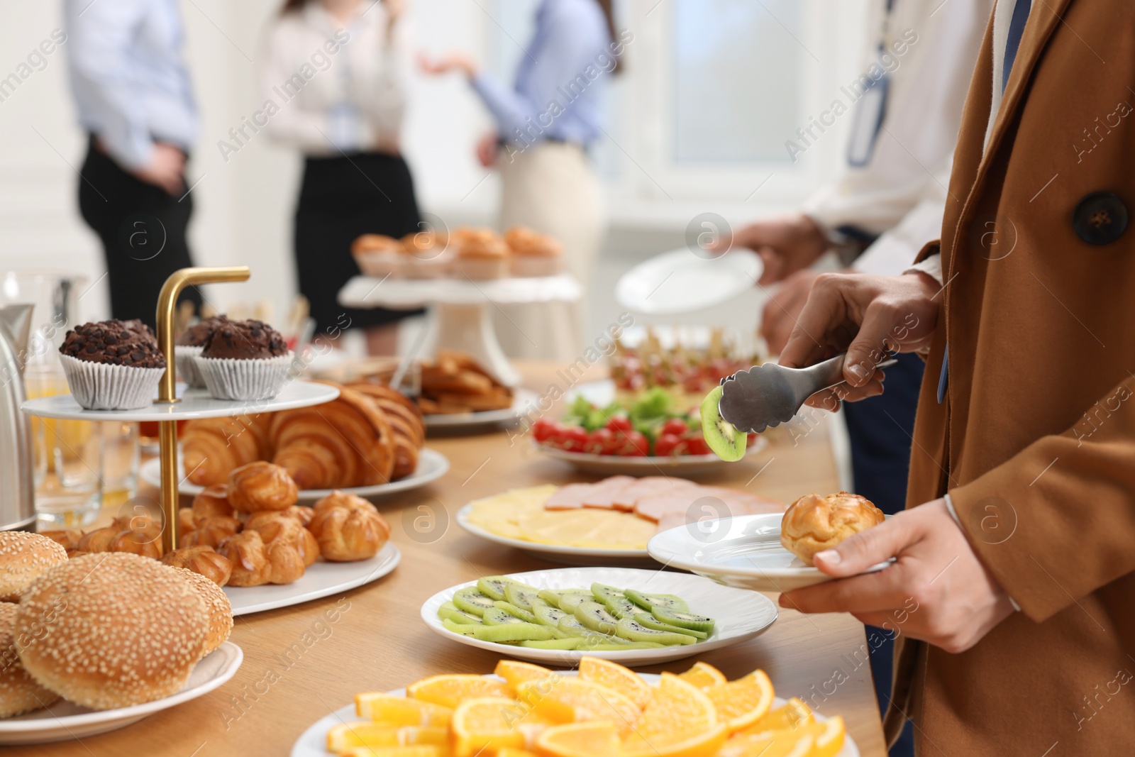 Photo of Coworkers having business lunch in restaurant, closeup