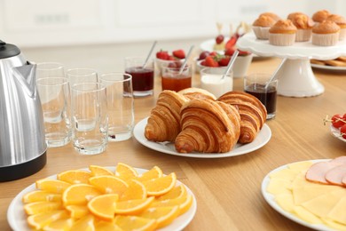 Different meals served on wooden table indoors. Buffet menu