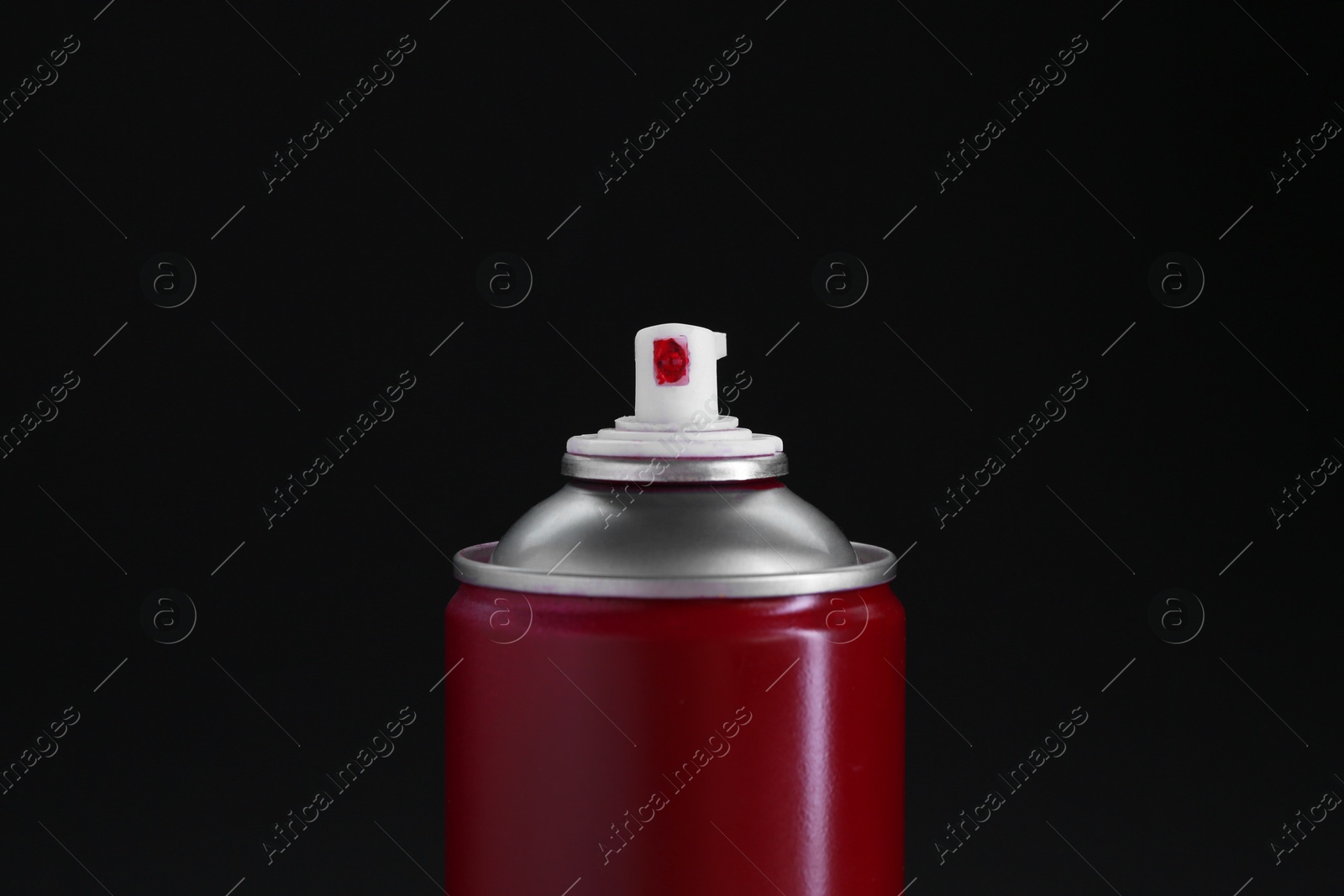 Photo of Red spray paint can on black background, closeup