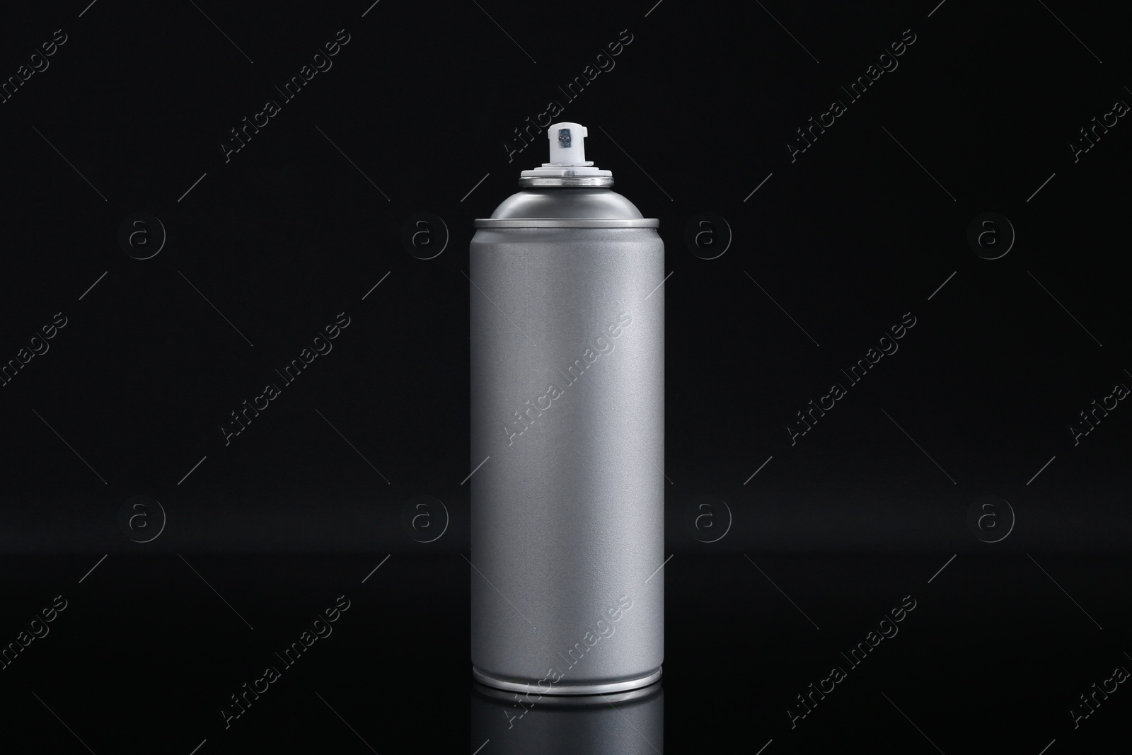 Photo of Gray spray paint can on black background