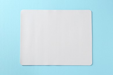 One mouse pad on light blue background, top view