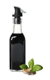 Photo of Balsamic vinegar in bottle, basil and spices isolated on white