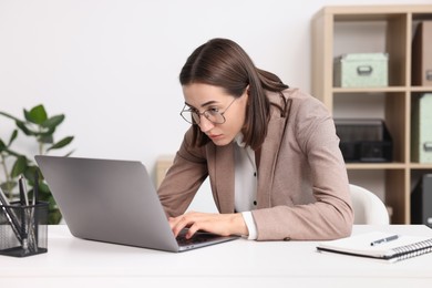 Woman with poor posture working in office