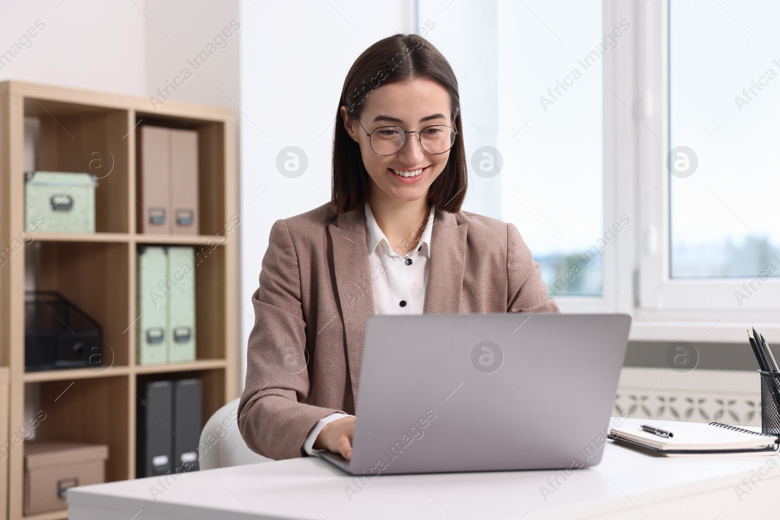 Photo of Woman with good posture working in office