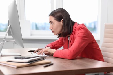 Woman with poor posture working in office