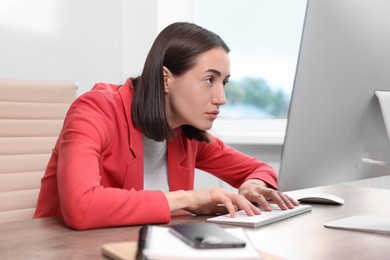 Woman with poor posture working in office