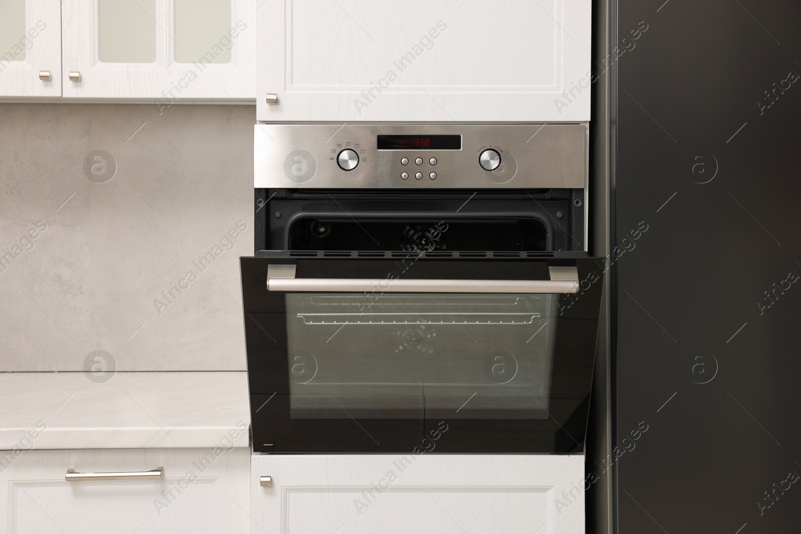 Photo of Open electric oven in kitchen. Cooking appliance