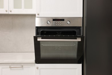 Open electric oven in kitchen. Cooking appliance