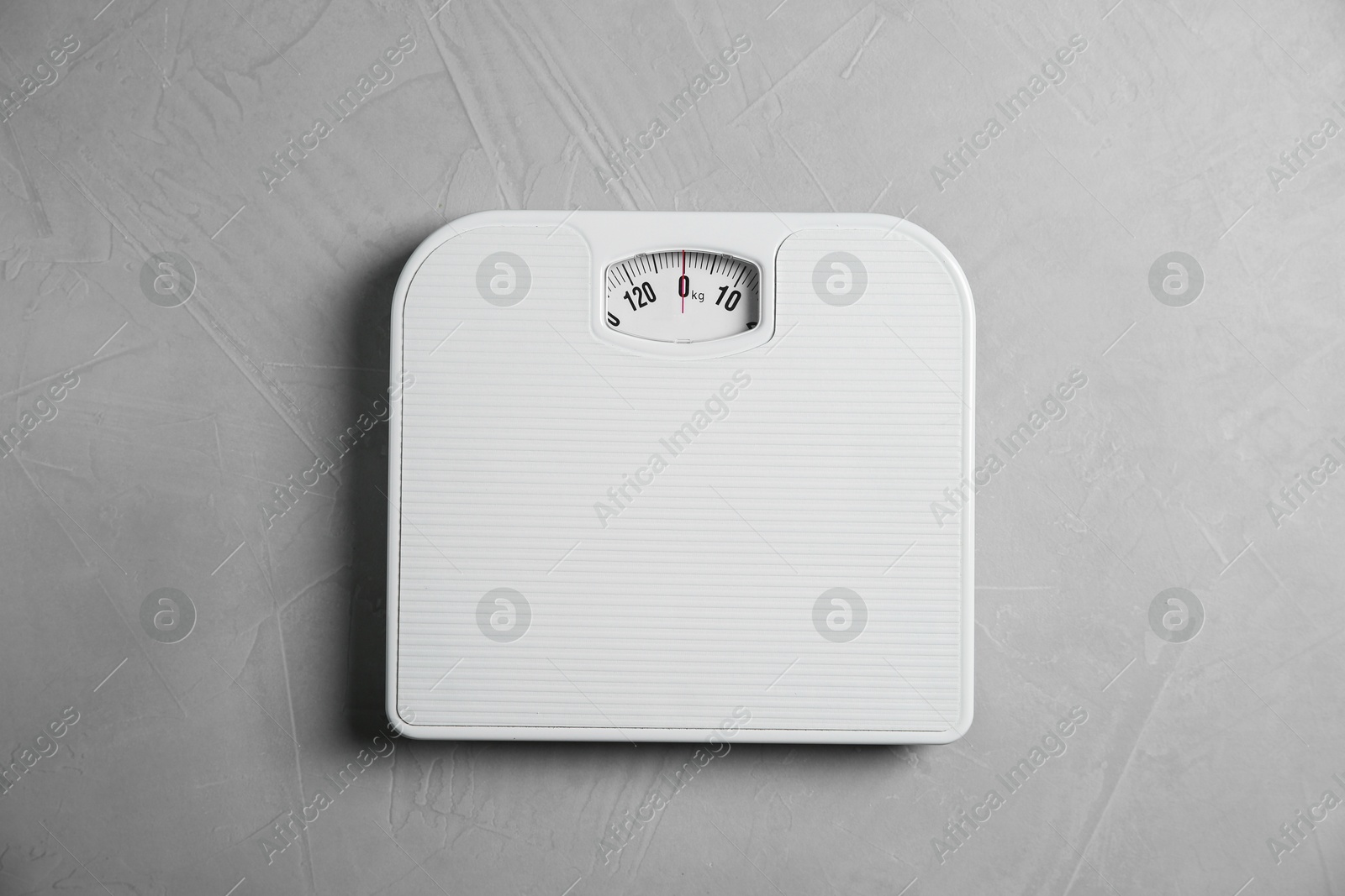 Photo of One bathroom scale on grey textured background, top view