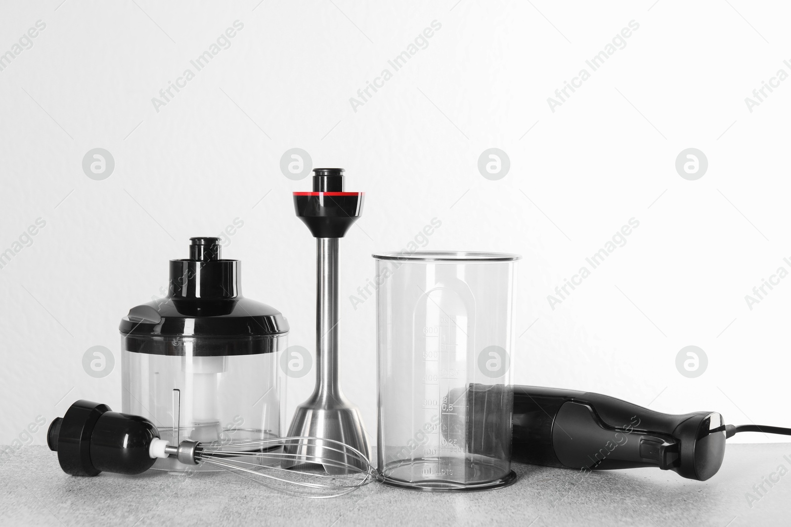 Photo of Hand blender kit on gray table against white background