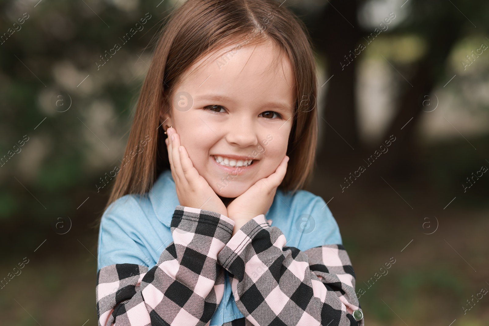 Photo of Portrait of happy little girl outdoors. Cute child