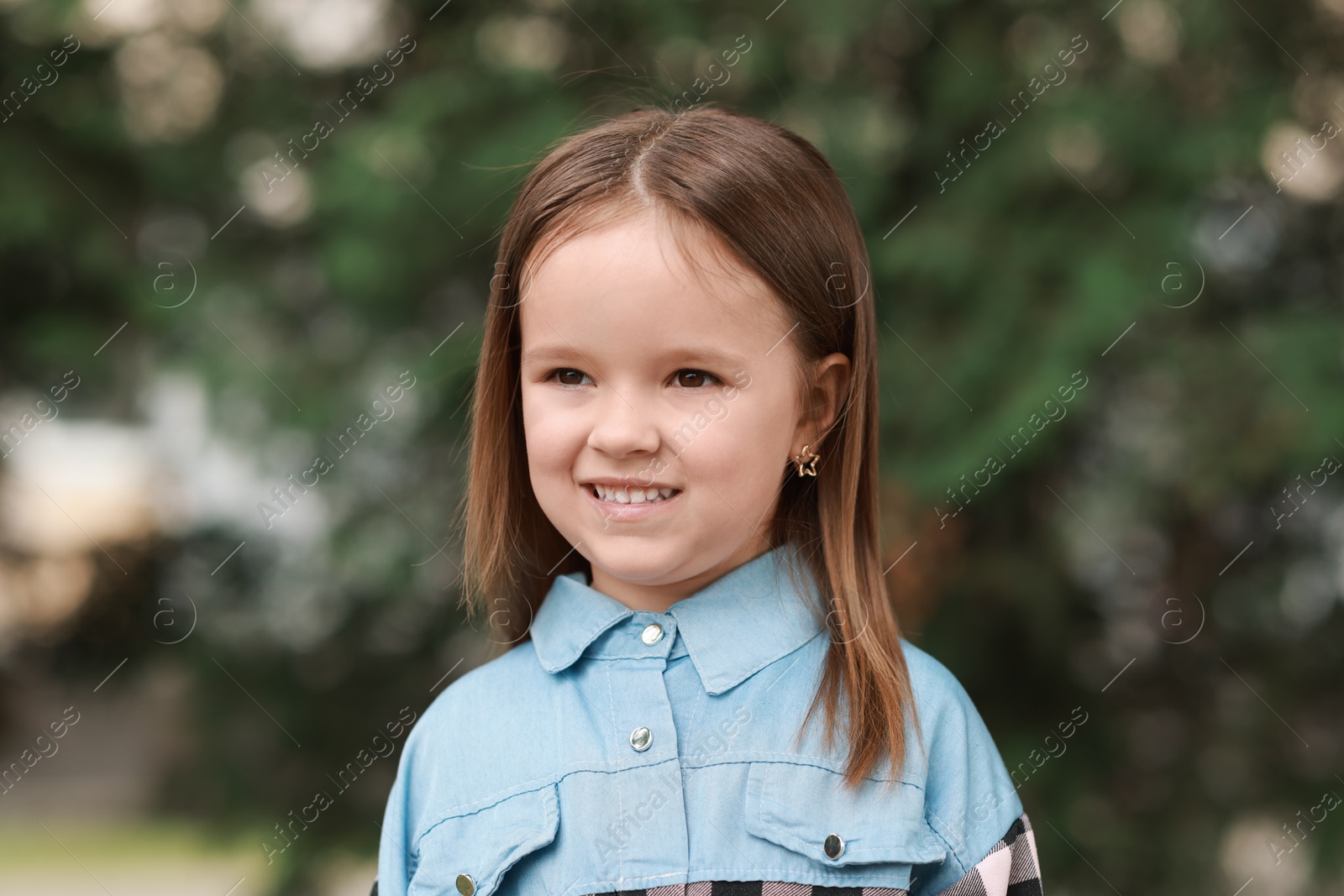 Photo of Portrait of happy little girl outdoors. Cute child