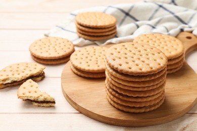 Fresh tasty sandwich cookies on wooden table