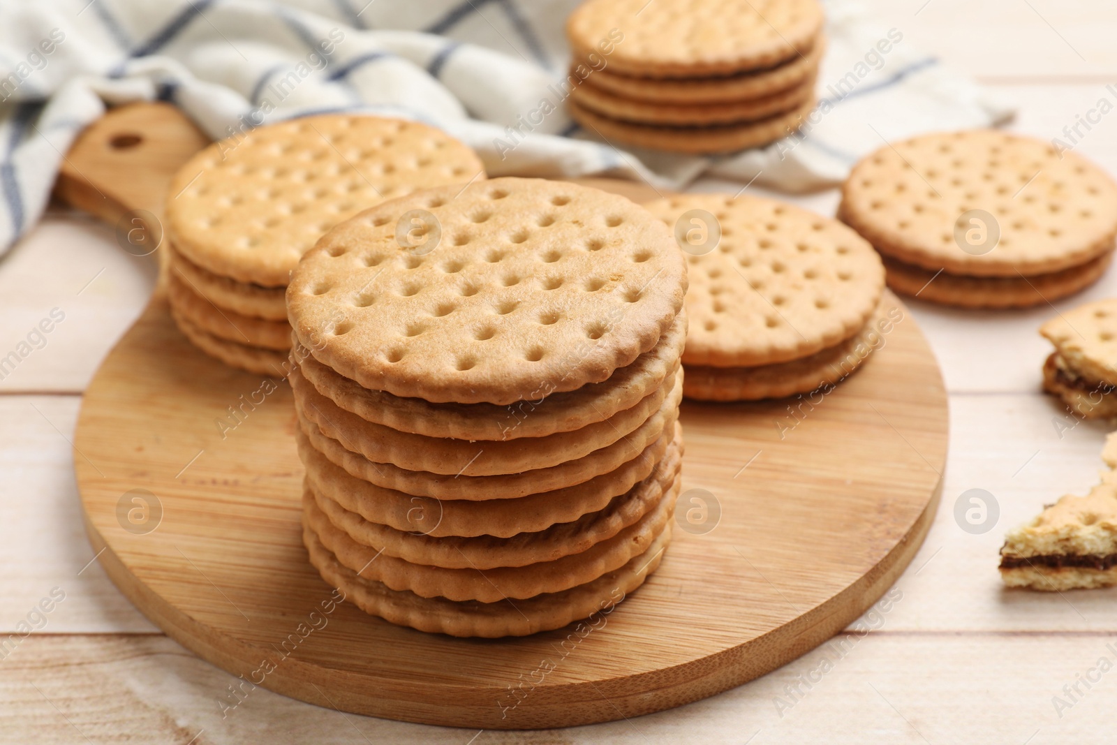 Photo of Fresh tasty sandwich cookies on wooden table, closeup