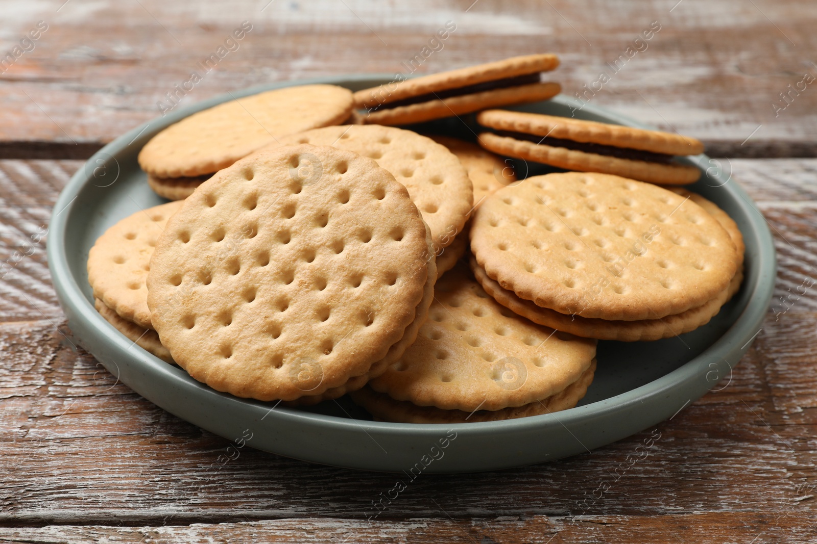 Photo of Tasty sandwich cookies on wooden table, closeup