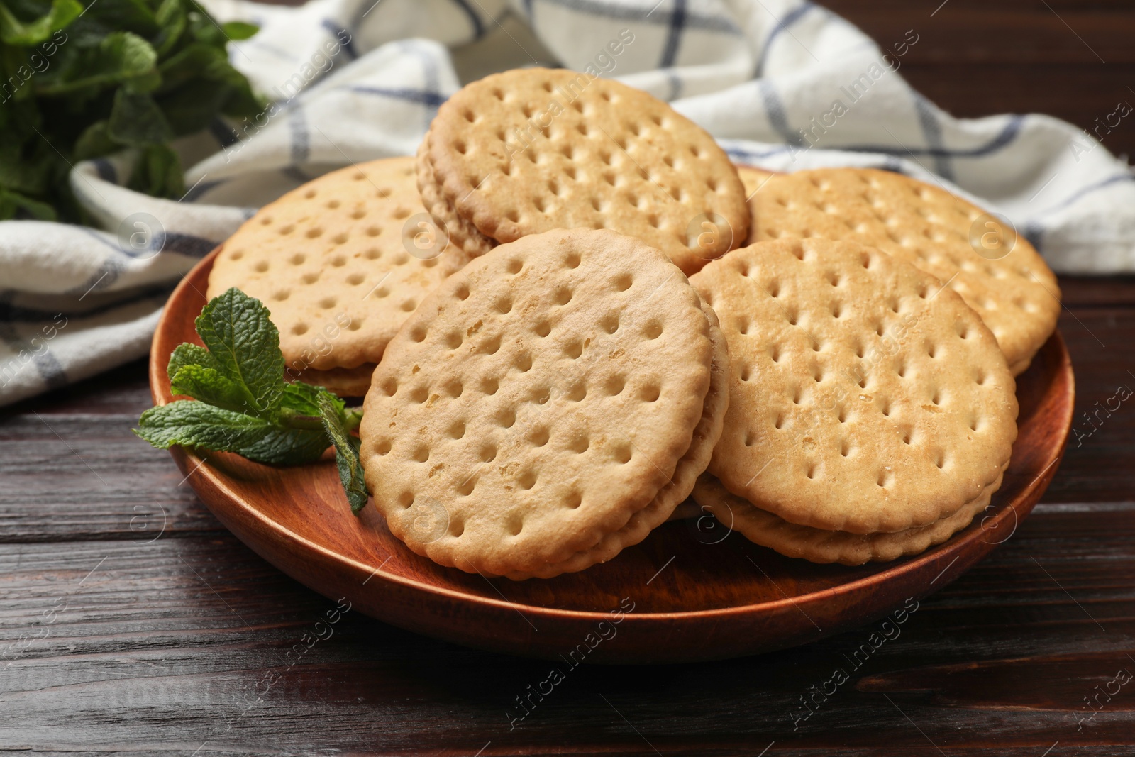 Photo of Tasty sandwich cookies on wooden table, closeup