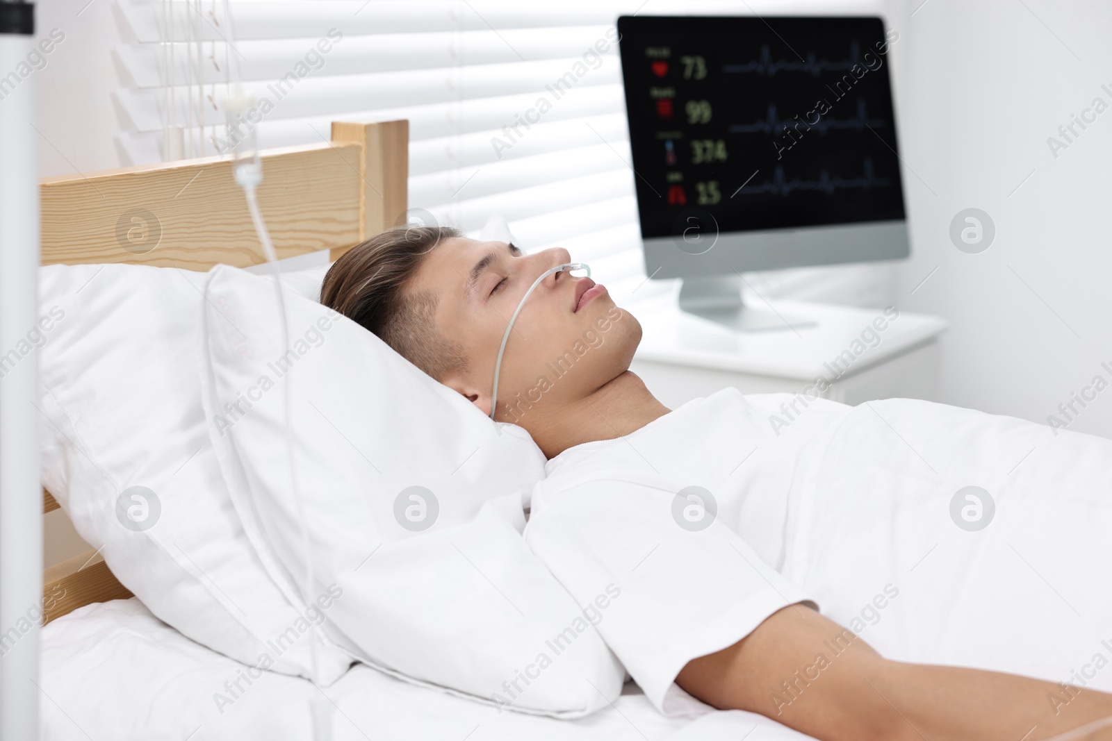 Photo of Coma patient. Young man sleeping in hospital bed