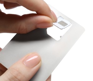 Photo of Woman removing SIM card from holder on white background, closeup