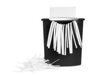 Photo of Destroying sheet of paper with shredder on white background