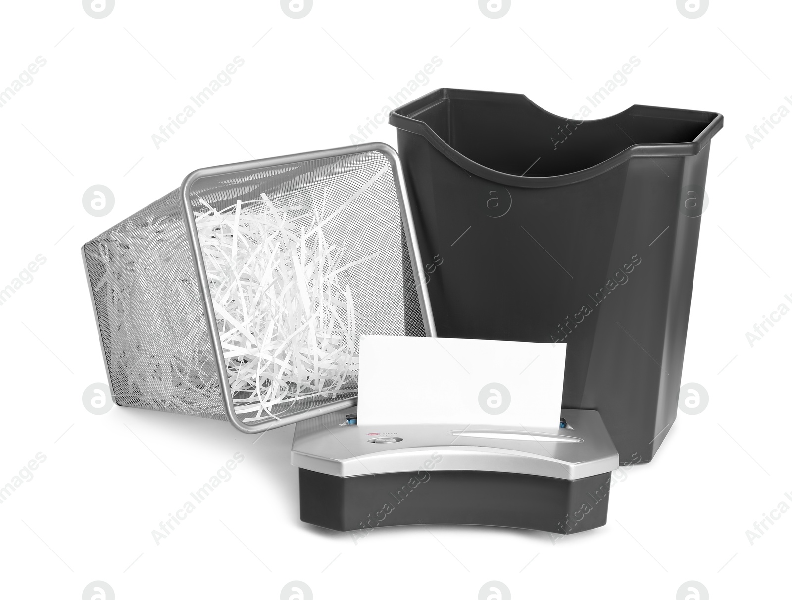 Photo of Shredder, metal basket and paper strips on white background