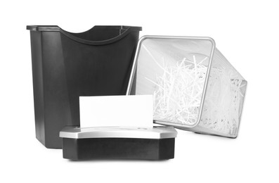 Photo of Shredder, metal basket and paper strips on white background