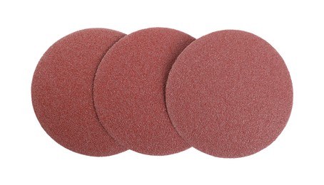 Photo of Coarse sandpaper disks isolated on white, top view