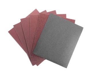 Photo of Sheets of sandpaper isolated on white, top view