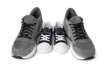 Photo of Big and small sneakers isolated on white