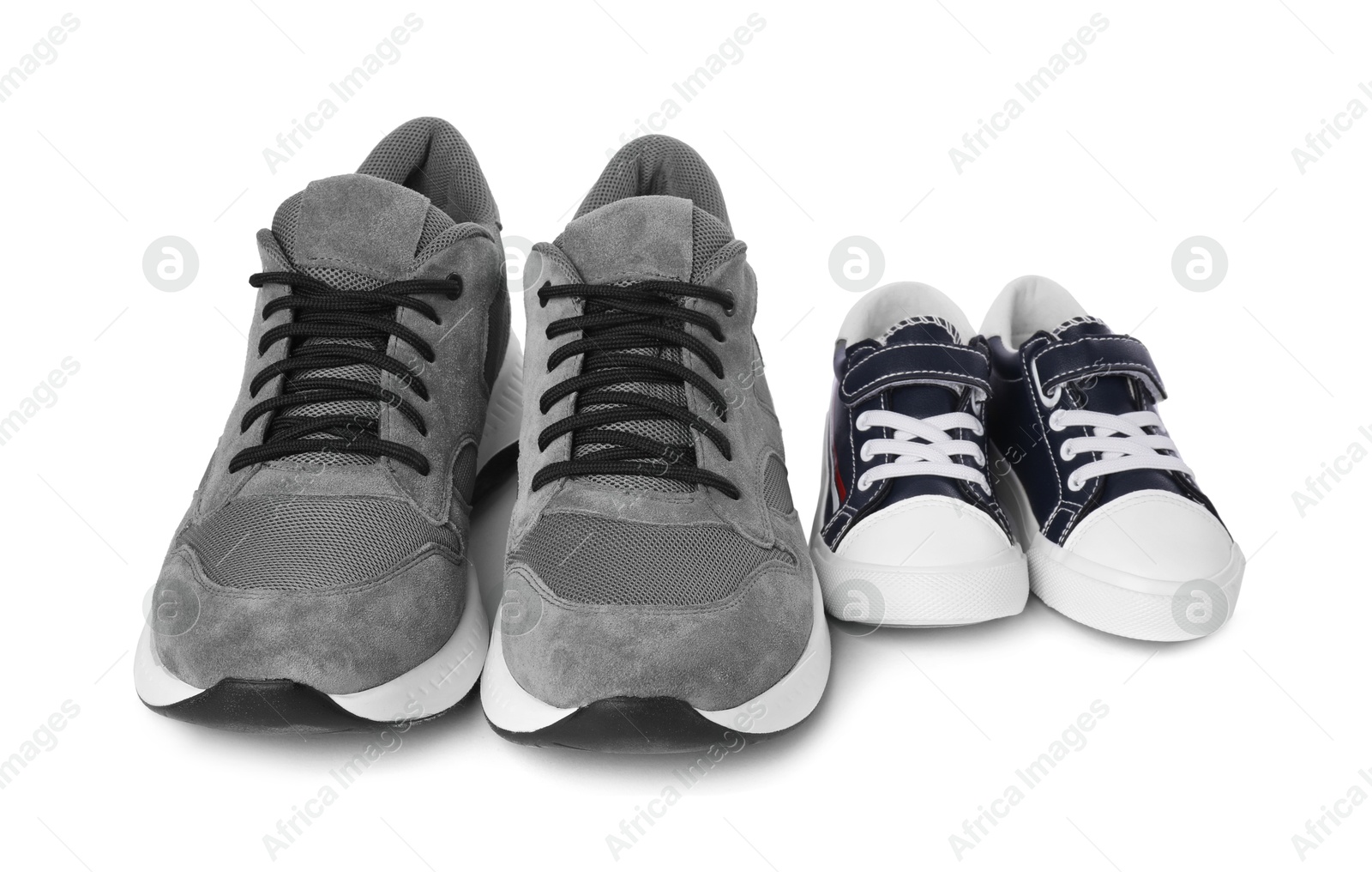 Photo of Big and small sneakers isolated on white