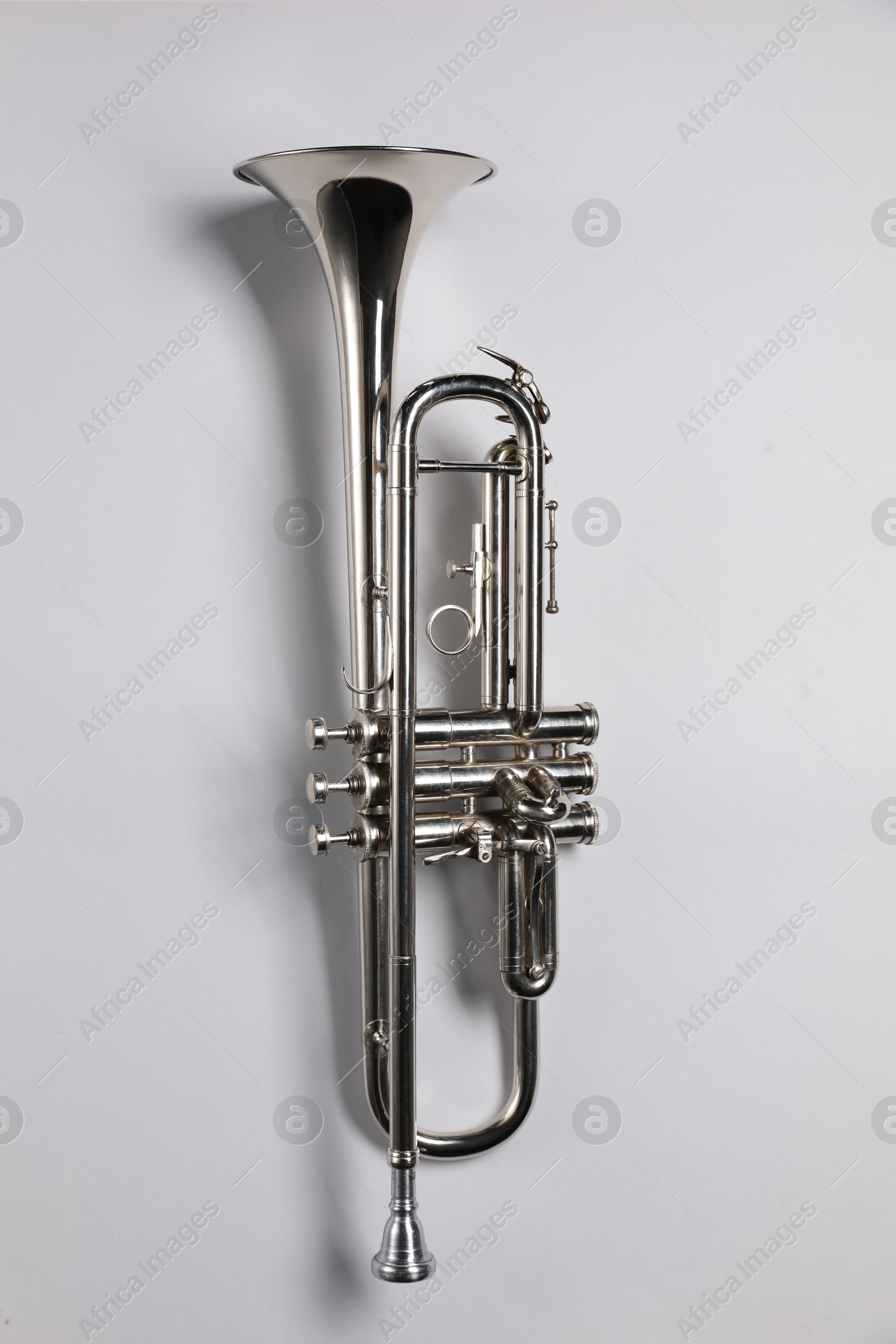 Photo of One trumpet on light background, top view