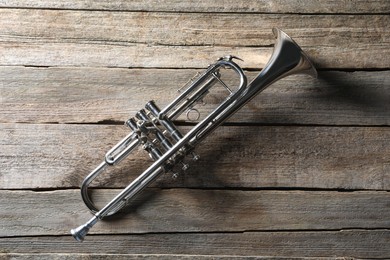 Trumpet on wooden table, top view. Wind musical instrument