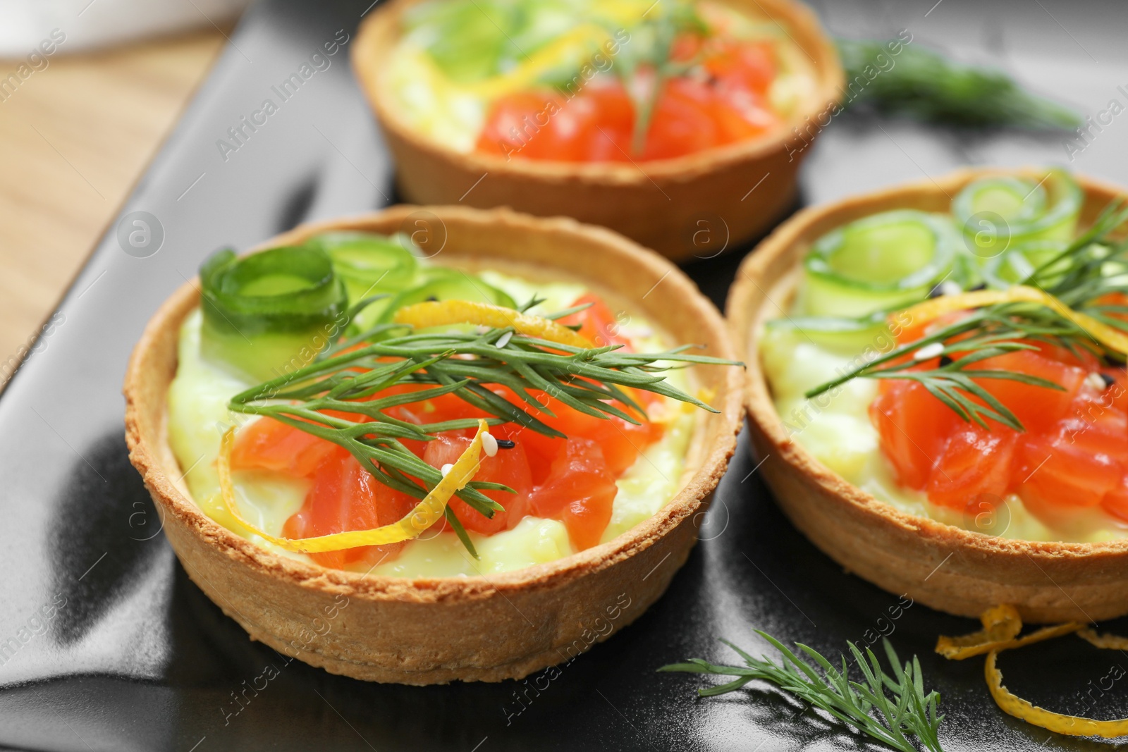 Photo of Delicious canapes with salmon on plate, closeup