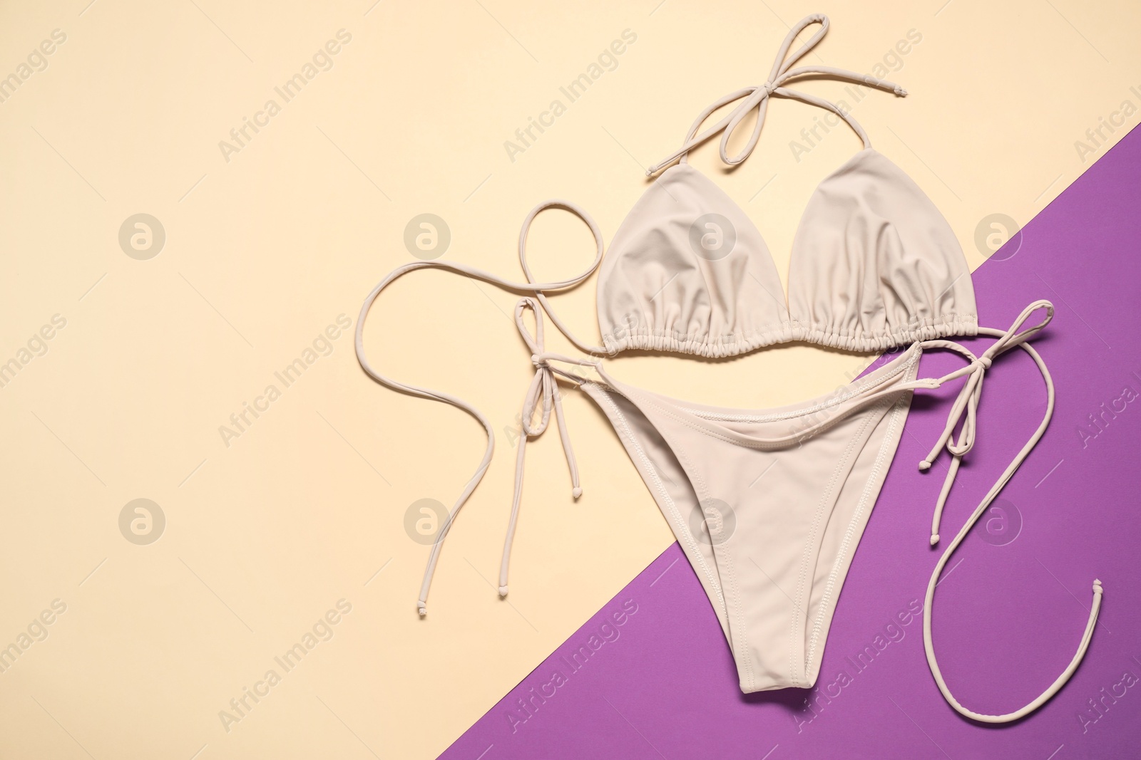 Photo of Beautiful swimsuit on color background, flat lay. Space for text