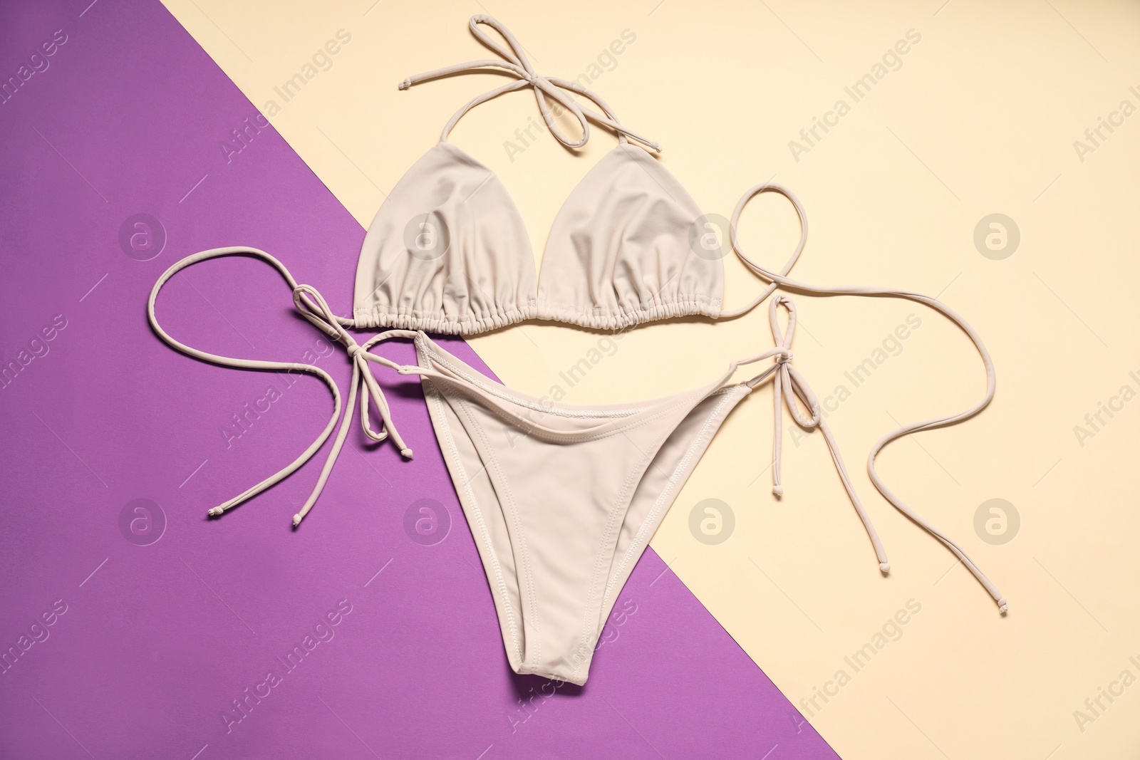 Photo of Beautiful swimsuit on color background, flat lay