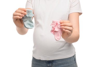 Expecting twins. Pregnant woman holding two pairs of socks on white background, closeup