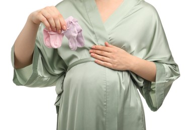 Photo of Expecting twins. Pregnant woman holding two pairs of socks on white background, closeup