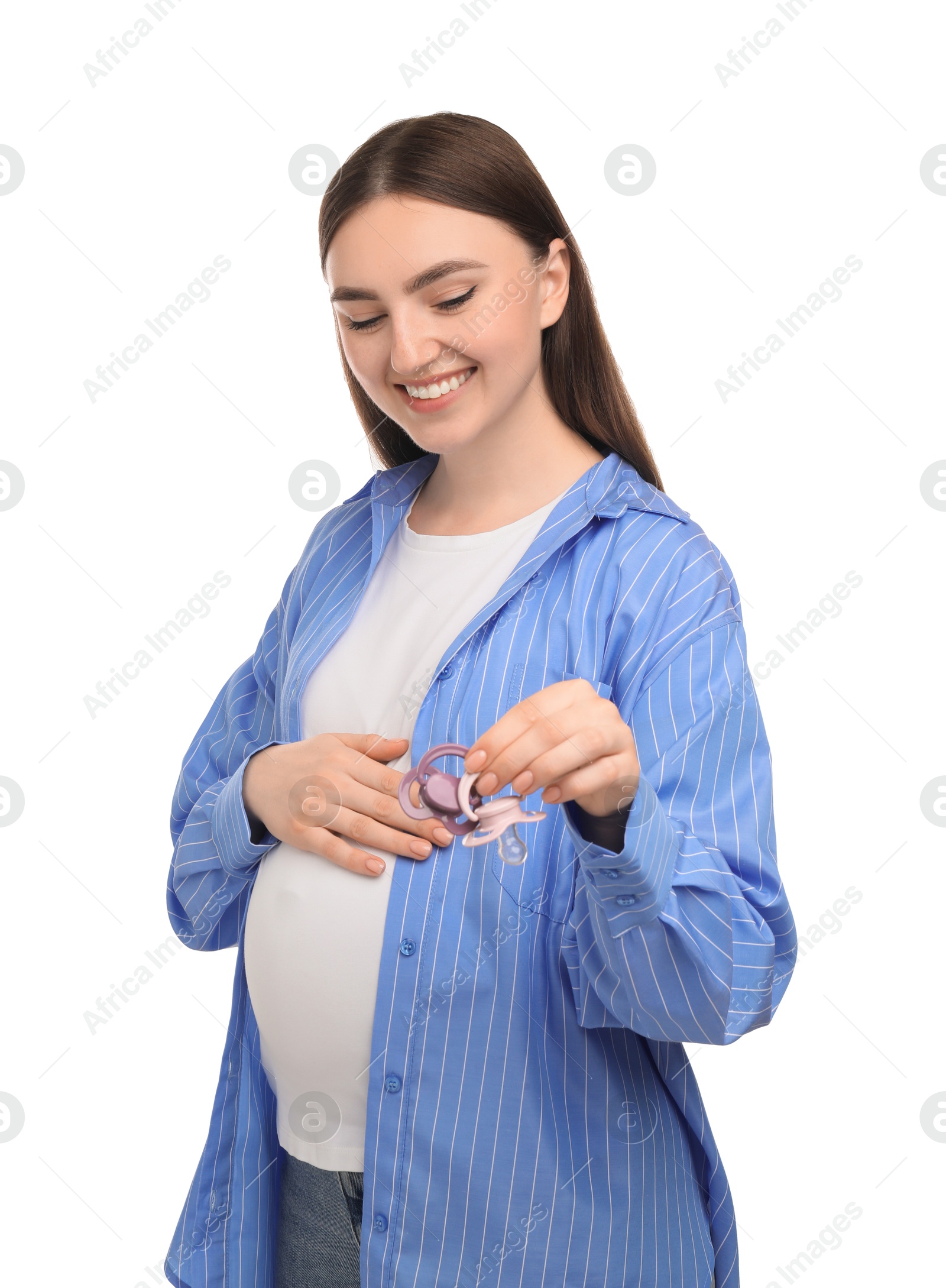 Photo of Expecting twins. Pregnant woman holding two pacifiers on white background