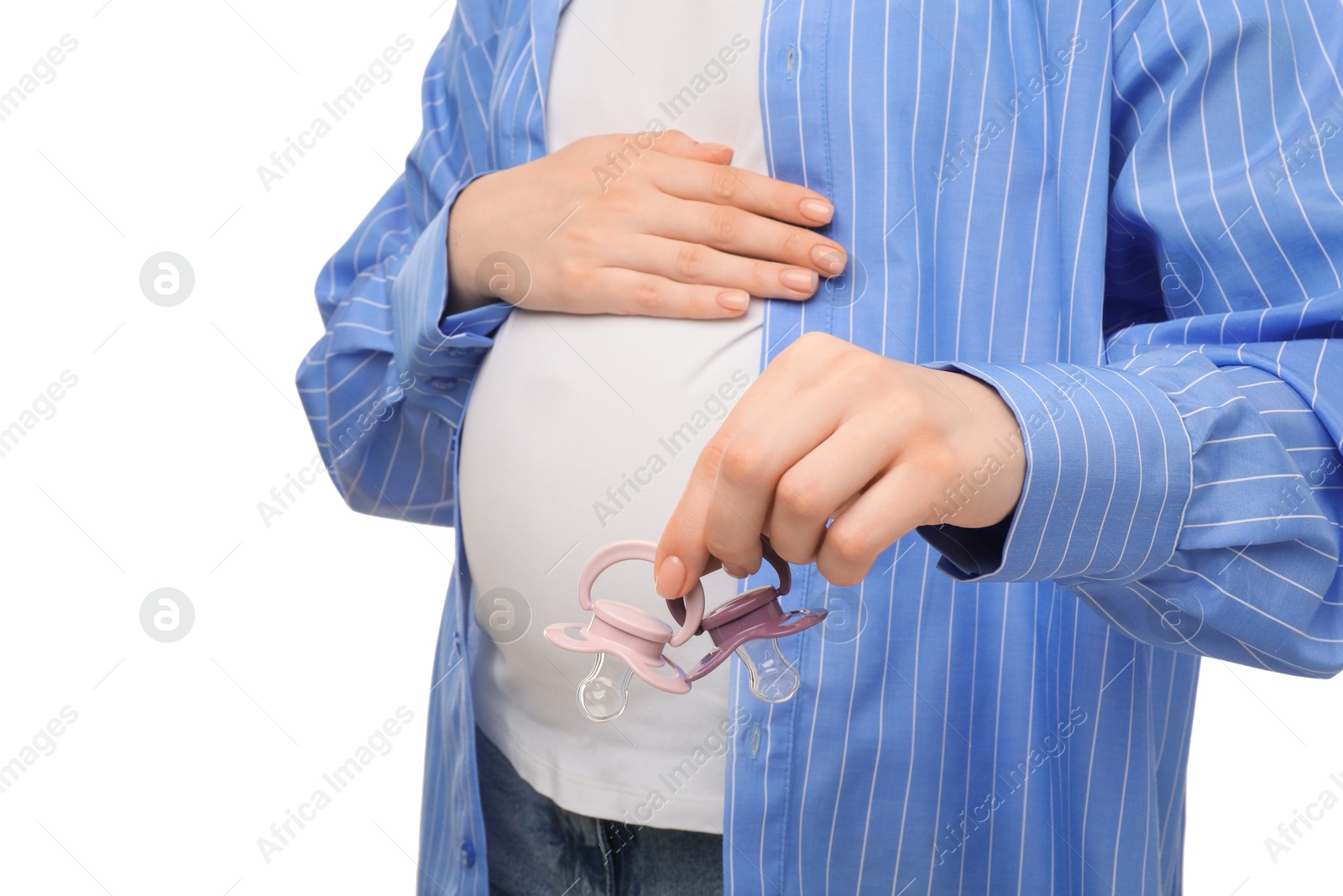 Photo of Expecting twins. Pregnant woman holding two pacifiers on white background, closeup