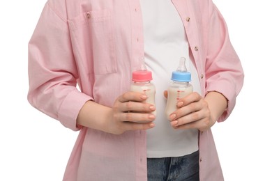 Expecting twins. Pregnant woman holding two bottles with milk on white background, closeup